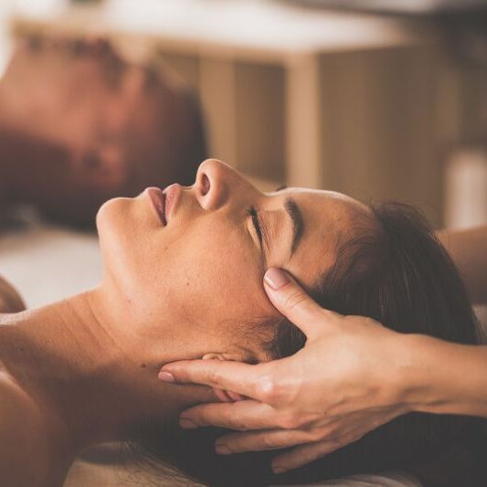 A woman receives a relaxing head and face massage.