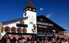 The Armbrustschützen tent at the Munich Oktoberfest behind traditional food and souvenir stands.