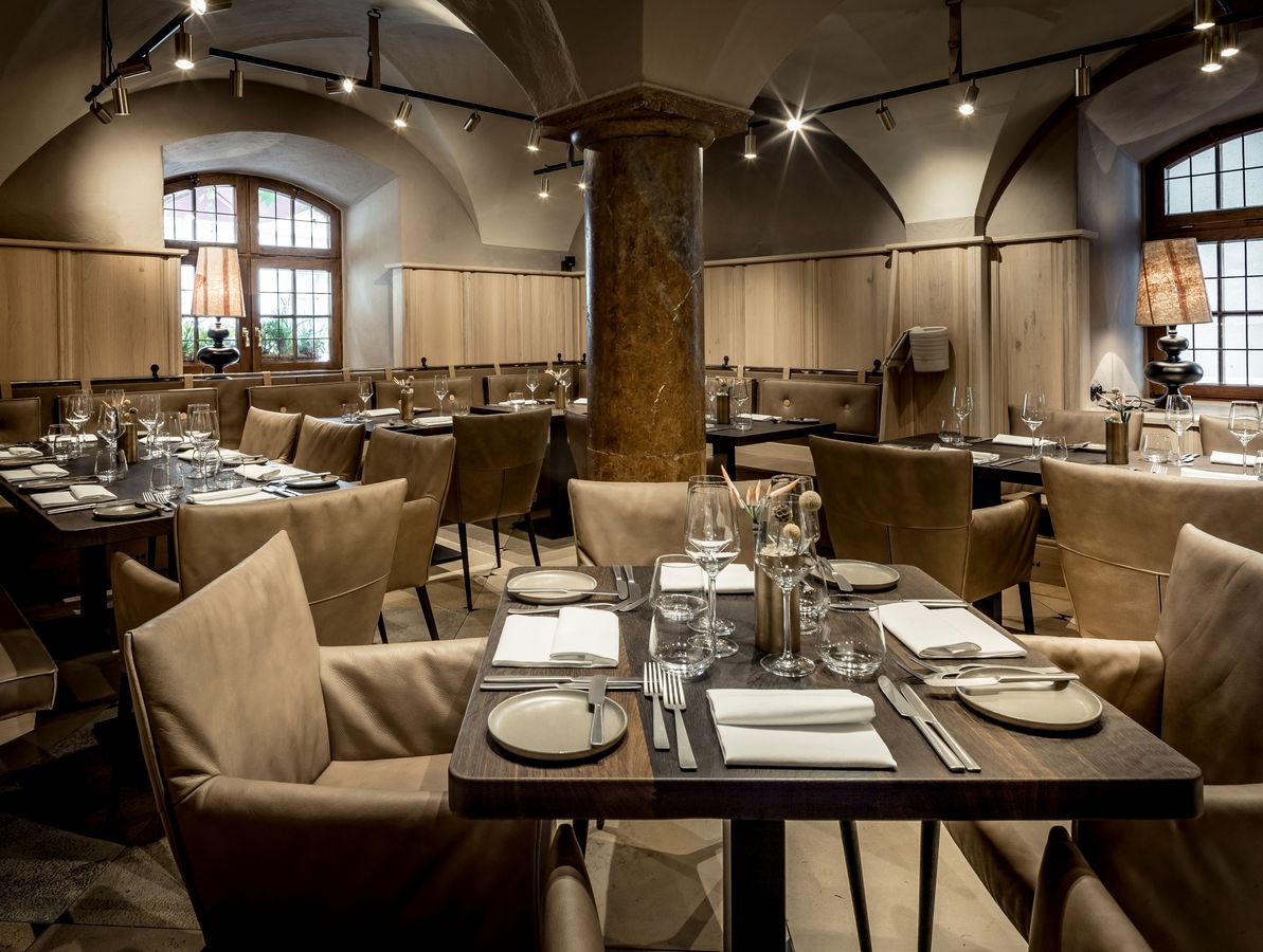 Set tables in the Pfistermühle restaurant of the Platzl Hotel.