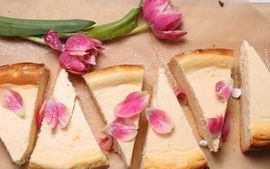 Pear chocolate tart decorated with pink tulips.